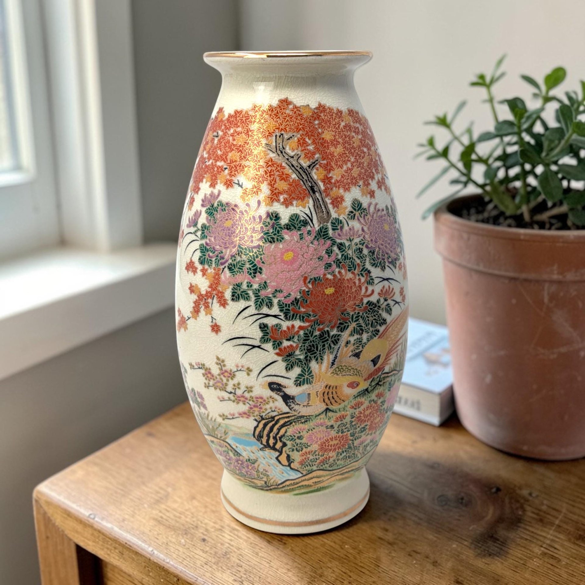 Tall cylindrical porcelain vase with a slightly flared rim and base. Features a hand-painted scene of colorful peonies and foliage in pink, yellow, and green. Fine, even crazing visible across the glazed surface.