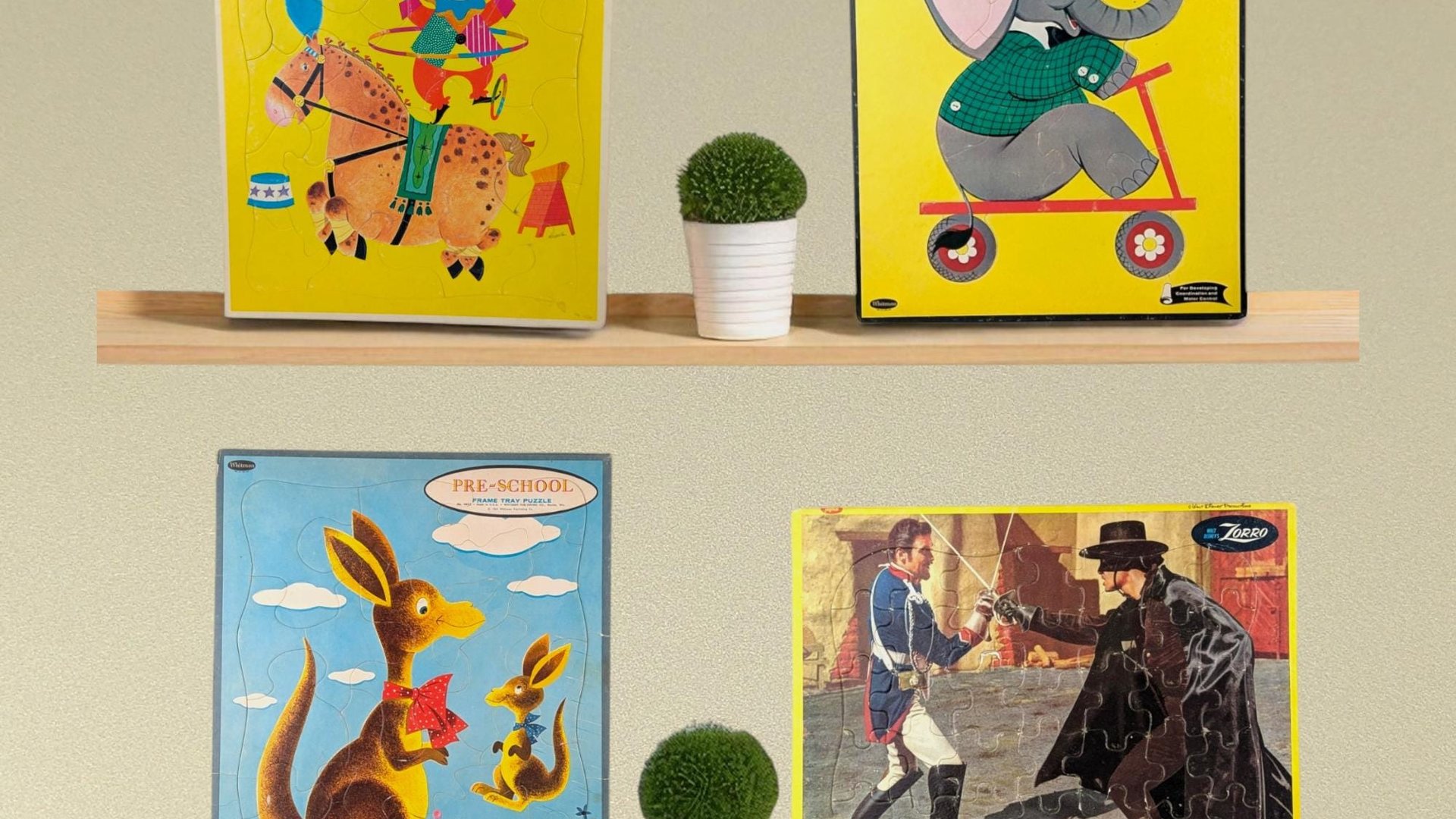 A set of four vintage cardboard tray puzzles featuring a circus clown, an elephant on a scooter, kangaroos, and a Zorro dueling scene. Rectangular silhouettes with vibrant primary colors and aged paper textures.