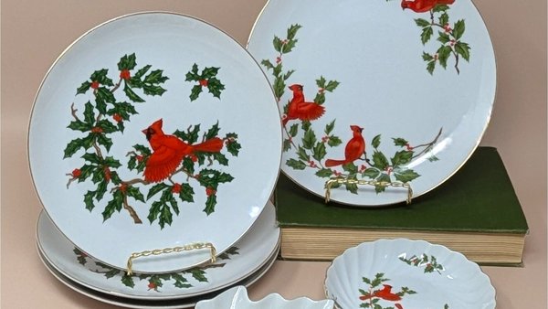 6-piece vintage Lefton Cardinal tableware set. Includes four white porcelain plates with hand-painted red cardinals and holly, one leaf-shaped candy dish, and one scalloped trinket bowl. Gold gilt rims throughout.