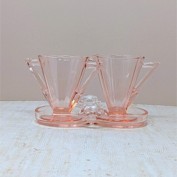 Vintage Cambridge pink glass sugar and creamer set on a matching double-well tray. Features 10-sided decagon panels and sharp geometric handles. 3.5 inches tall.