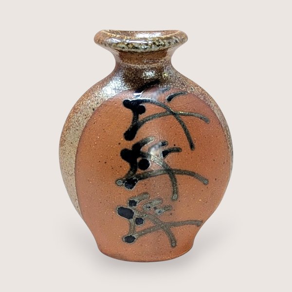 Vintage Brad Lee Henry studio pottery vase. Features a bulbous body in earthy red-brown with a metallic tenmoku drip glaze and black calligraphic slip-painted accents. 5 inches tall.