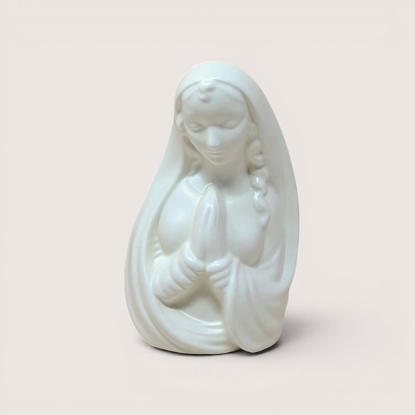 Mid-century white ceramic planter featuring a bust of a praying Madonna. Smooth, semi-matte ivory finish, flowing drapery, and serene facial expression. Hollow back for plants or stems.