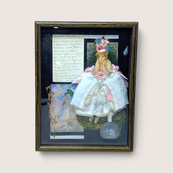 Vintage 1980s handmade mixed media shadow box collage featuring a 3D handkerchief skirt and Jontue perfume bottle.