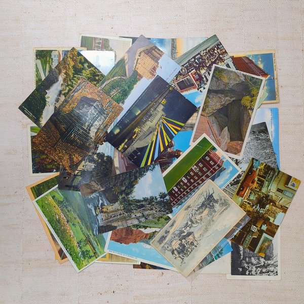 A scattered arrangement of forty vintage postcards featuring various historical landscapes, city architecture, and travel scenes against a neutral background.