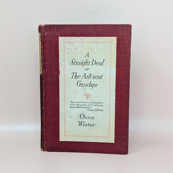 A burgundy cloth-bound hardcover book with a cream-colored title label featuring black typography and a small floral accent against a neutral background.
