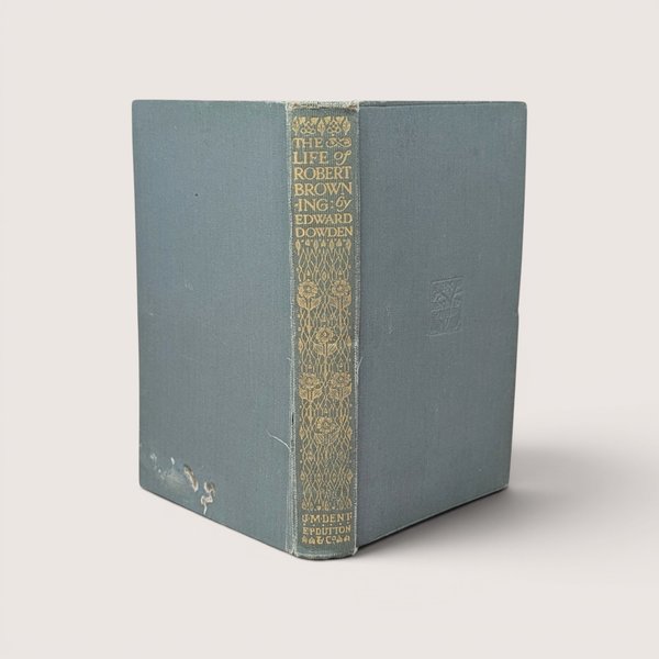 Antique book titled The Life of Robert Browning by Edward Dowden with a faded blue cloth cover and an ornate gold gilt decorated spine.