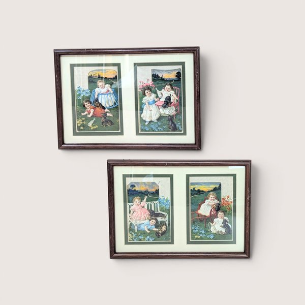 A set of two framed wall hangings, each containing two vintage-style advertising cards featuring Victorian children and puppies in pastoral outdoor settings.