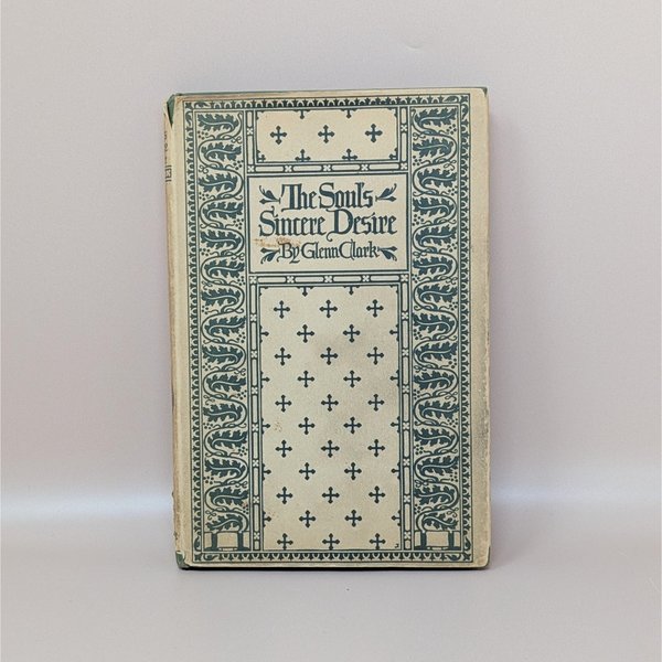 A vintage hardcover book with a cream and teal green patterned cover featuring crosses and floral borders, titled The Soul's Sincere Desire by Glenn Clark.