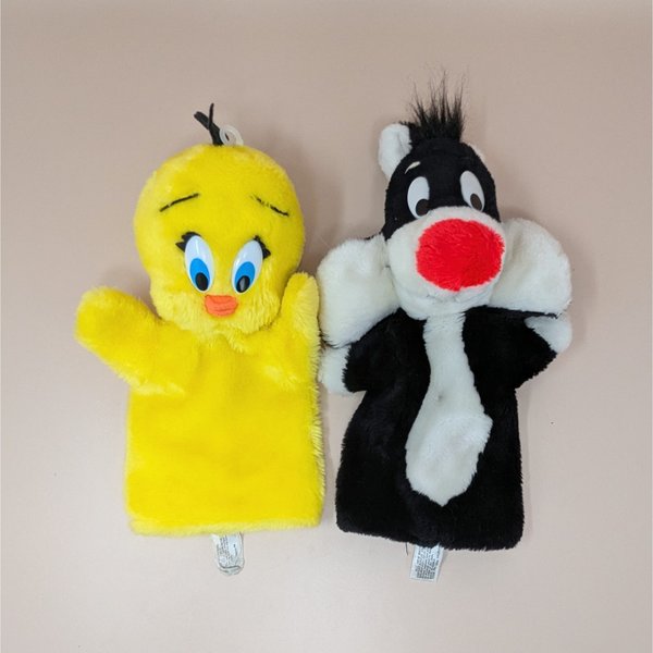 A pair of vintage 1971 plush hand puppets featuring Looney Tunes characters Tweety Bird and Sylvester the Cat.