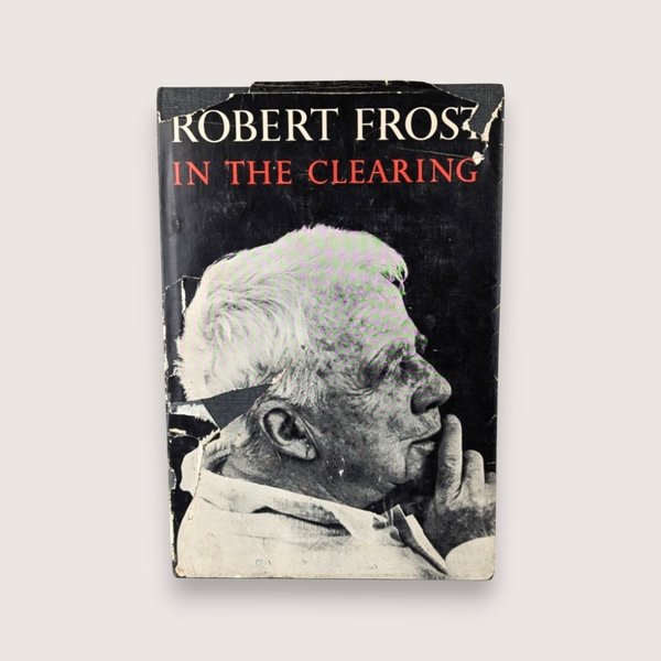 Distressed dust jacket of a 1962 Robert Frost poetry book titled In the Clearing featuring a black and white portrait.