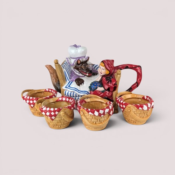 Department 56 Little Red Riding Hood ceramic teapot with wolf in bed and four matching basket weave tea cups.