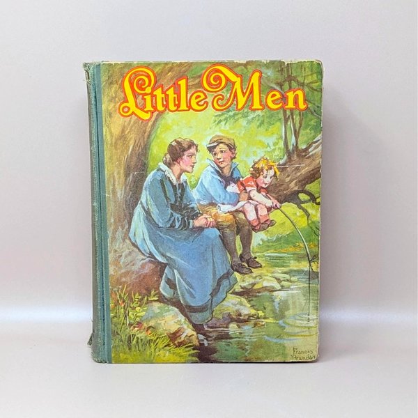 A vintage 1928 hardcover book titled Little Men by Louisa M. Alcott featuring a color illustration by Frances Brundage of children fishing by a stream