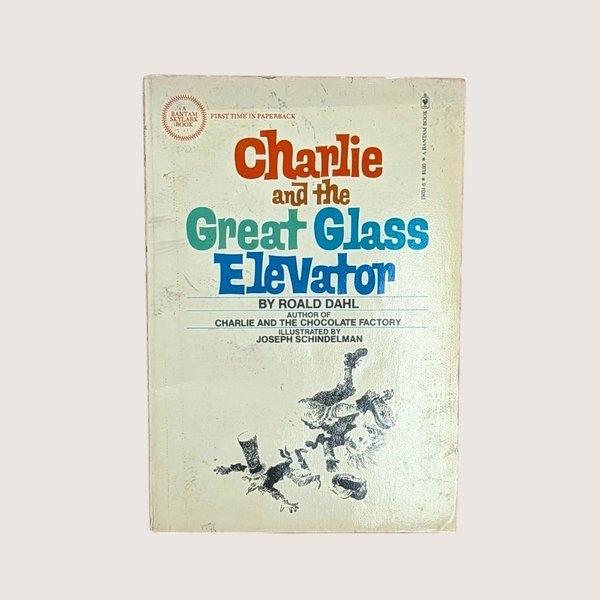 A vintage paperback cover of Charlie and the Great Glass Elevator by Roald Dahl with illustrations by Joseph Schindelman.