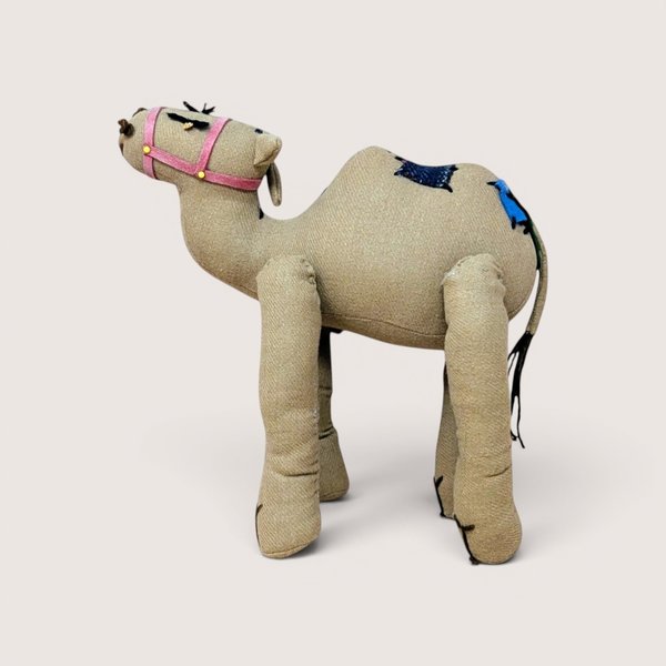 A vintage small Gund Lumpy the Camel plush stuffed animal standing upright on a plain background.