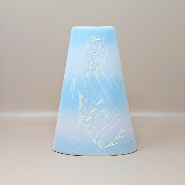 A conical studio pottery vase with a soft blue and pink ombre glaze. The front features an etched sgraffito design of stylized geometric and avian motifs, shown against a neutral background.