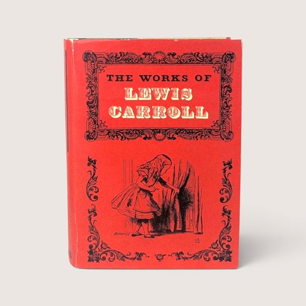 A vintage 1965 hardcover edition of The Works of Lewis Carroll with a vibrant red illustrated dust jacket.