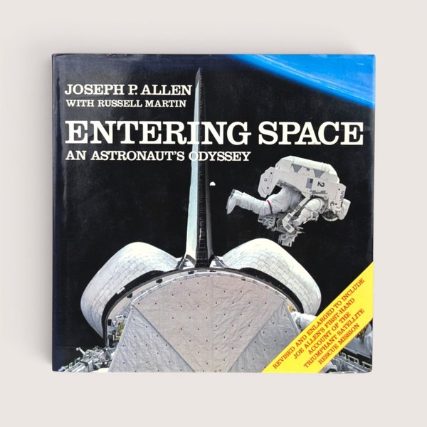 A vintage hardcover copy of Entering Space An Astronaut's Odyssey by Joseph P Allen featuring a space shuttle illustration.
