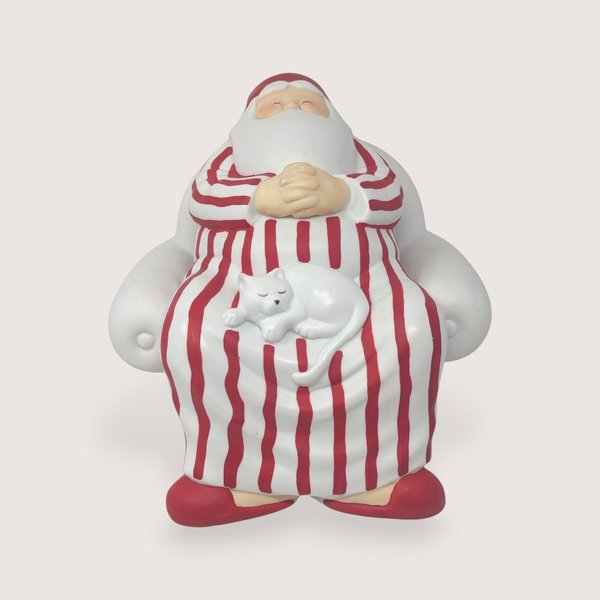 Vintage 1990s Dept 56 matte white bisque porcelain Santa in red striped pajamas with a sleeping white cat on his lap.  
