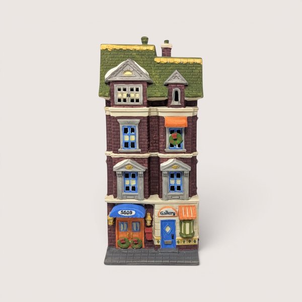 A handpainted porcelain Dept 56 5609 Park Ave Townhouse building on a linen background
