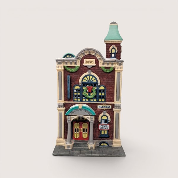 A handpainted porcelain Dept 56 Arts Academy building on a linen background