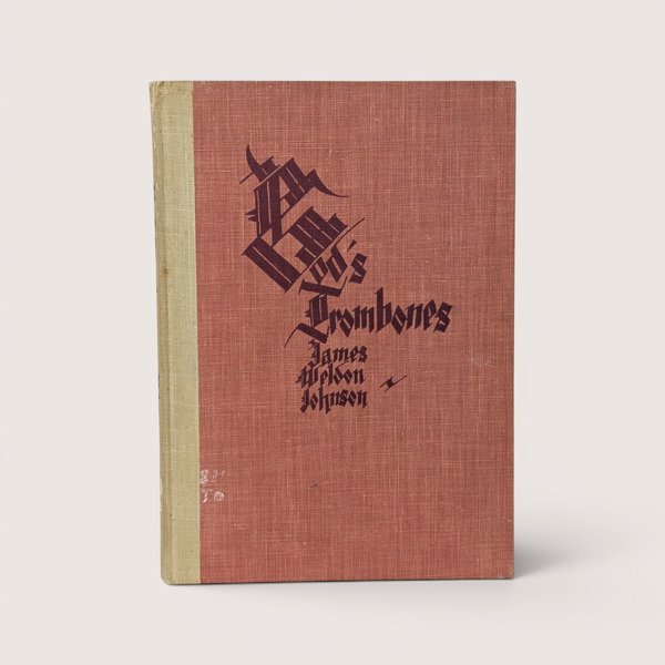 A vintage hardcover book with a textured red cover and stylized black gothic lettering on a plain background