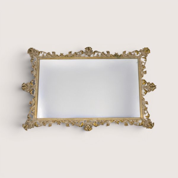 A large antique rectangular vanity tray featuring an ornate gold metal filigree border frame and a mirrored glass surface.