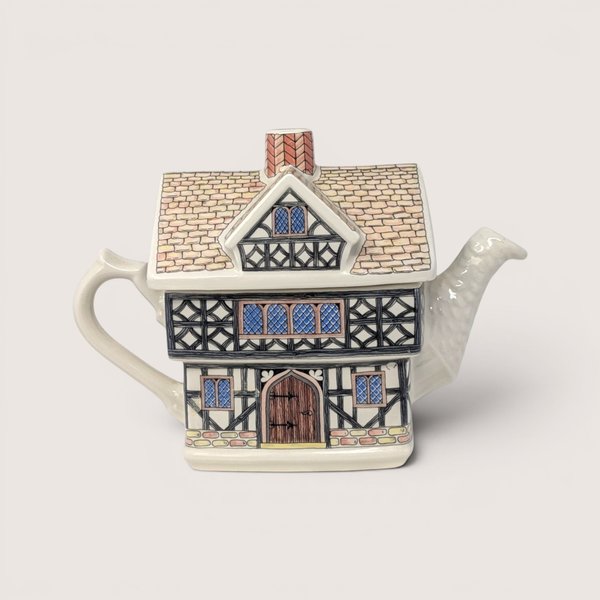 A vintage Sadler ceramic teapot shaped like a two-story English Tudor house with half-timbered architectural details.