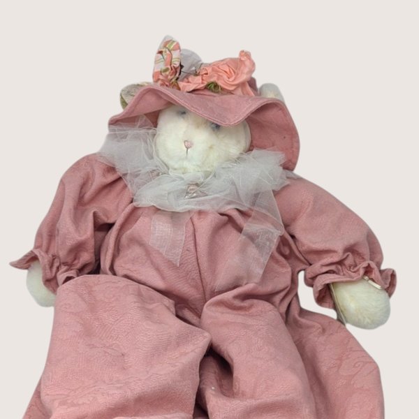 A large vintage 1994 Bunnies By the Bay plush artisan cat doll named Jolie wearing a dusty rose romper and hat.