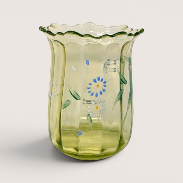 Antique green uranium glass vase with ruffled rim and hand painted flowers glowing under UV blacklight.