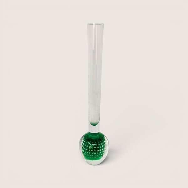 Slender clear glass bud vase with a heavy green bulbous base containing a controlled bubble pattern on a solid background.