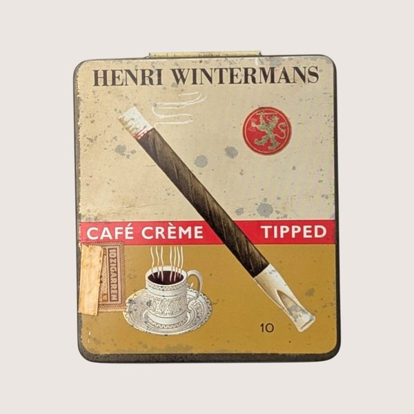 Vintage empty Henri Wintermans Cafe Creme tipped cigarillos tin with a graphic of a cigarillo and a coffee cup.