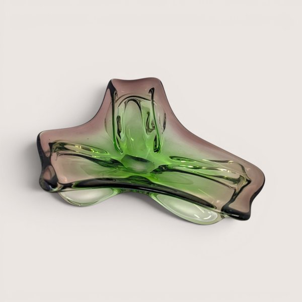 A heavy tri-cornered vintage art glass dish with a vibrant green center shifting to smoky amethyst purple edges