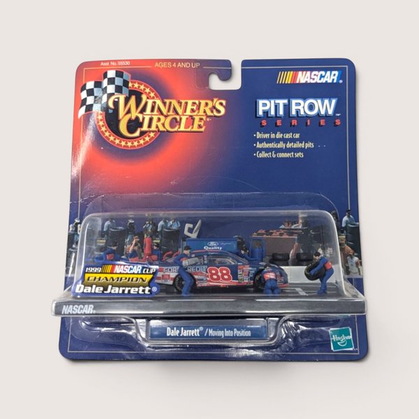 A vintage sealed NASCAR toy package featuring a Dale Jarrett pit stop diorama with a miniature race car and crew figures