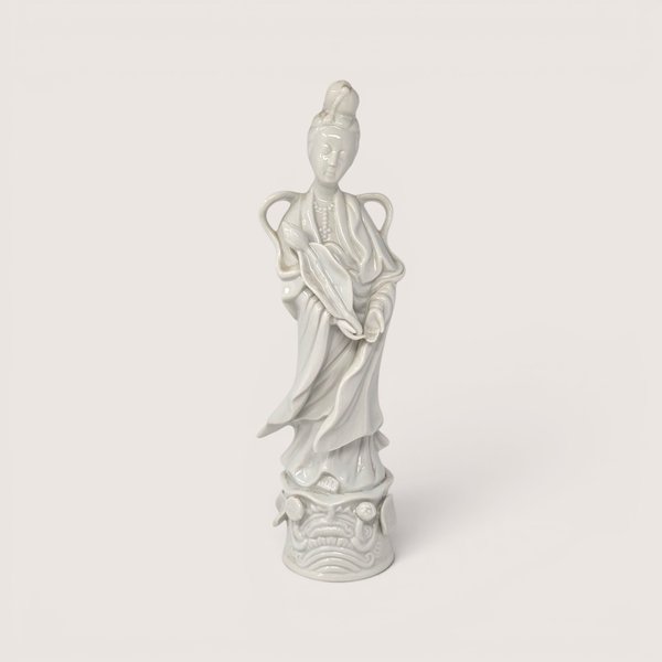 Vintage white ceramic Homco Quan Yin figurine standing on an ornate pedestal.