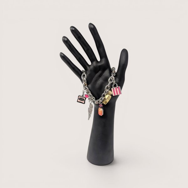 Y2K Victoria's Secret silver tone charm bracelet featuring iconic perfume and wing charms.