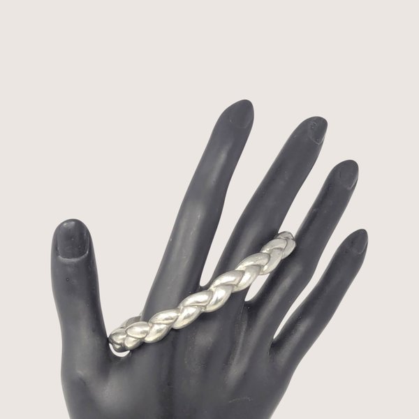 Vintage pewter braided bangle bracelet with a dimensional woven metal design.