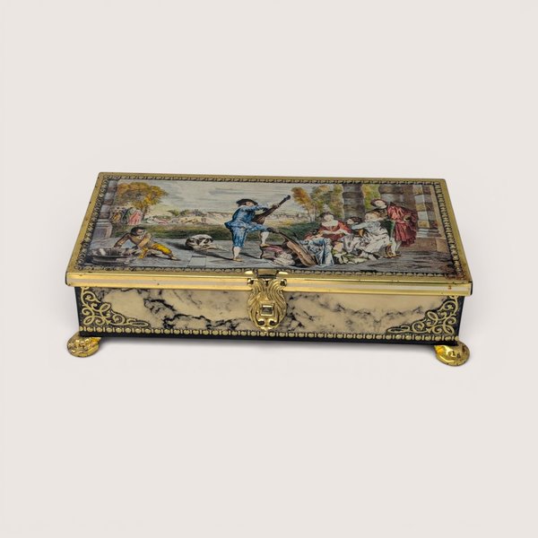 Vintage Jamin metal candy tin featuring a Renaissance scene lid and faux marble sides with gold feet.