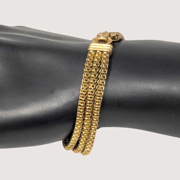 Vintage gold tone multi-strand textured bracelet with a secure fold-over clasp.