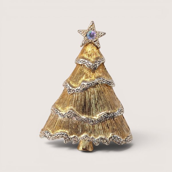 Vintage Liz Claiborne gold tone Christmas tree brooch featuring textured branches, rhinestone garland, and a star topper.