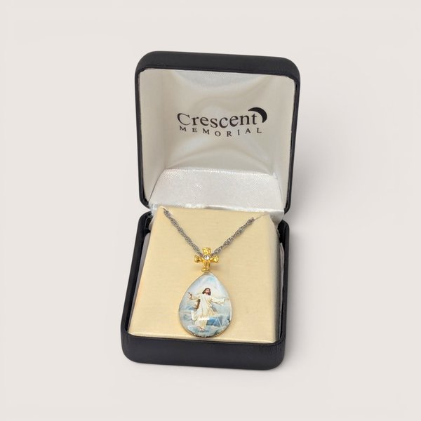 Vintage Crescent Memorial teardrop intaglio pendant with a cross bail, displayed in its original box with a chain.