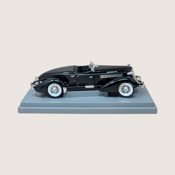 Vintage black ERTL American Muscle 1935 Auburn 851 Speedster diecast model in original worn display box.