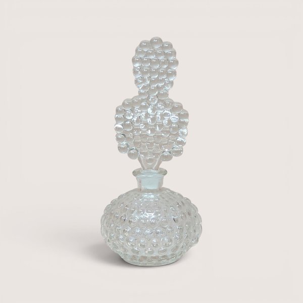 Vintage clear glass perfume bottle with a textured bubble pattern and unique bubble-shaped stopper.