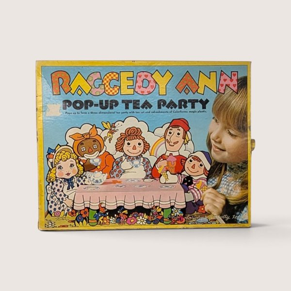 1974 vintage Raggedy Ann Pop-Up Tea Party Colorforms box featuring colorful character illustrations of Raggedy Ann and friends.