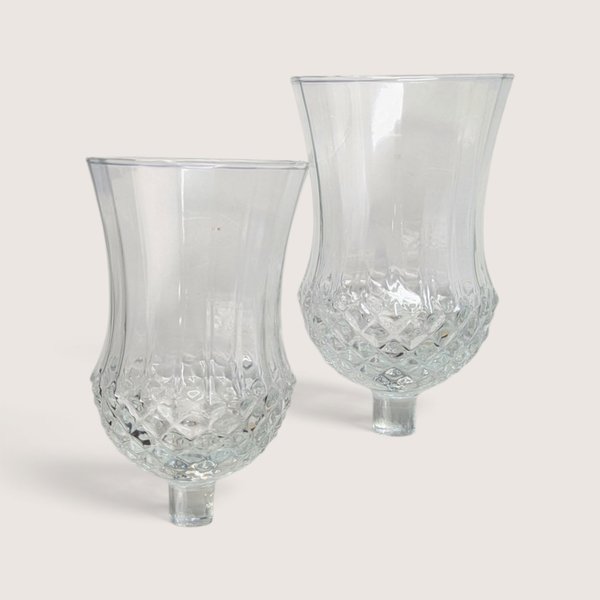 Pair of vintage clear glass peg votive candle holders with textured diamond cut lower bowls.