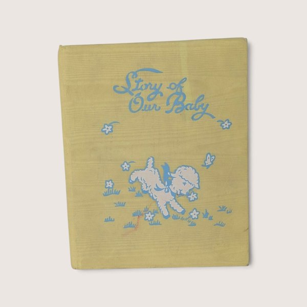 Vintage 1971 baby memory book titled The Story of Our Baby featuring illustrated illustrations by The Hendersons and a yellow fabric cover.