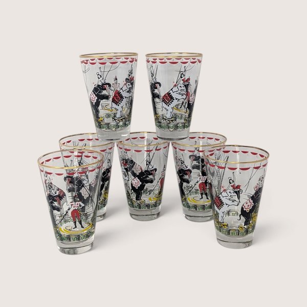 Vintage set of clear glass circus tumblers featuring performing elephants, circus acts, and gold rims.