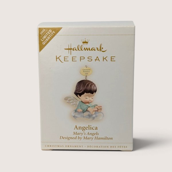 A boxed 2006 Hallmark Keepsake Marys Angels Angelica limited quantity ornament featuring an angel on a cloud.