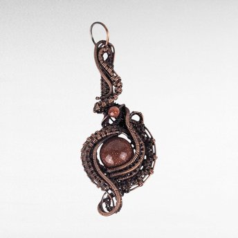 Copper wire wrapped pendant with red goldstone beads.