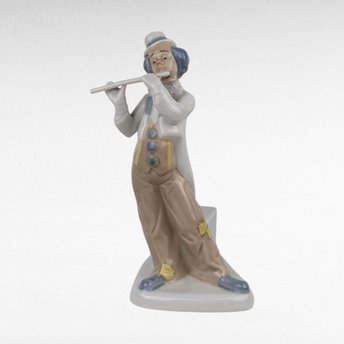 Vintage Porcelain clown figurine holding a flute.