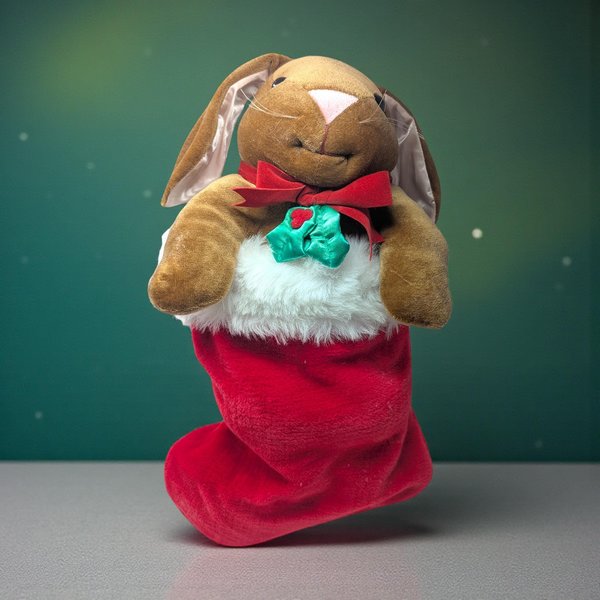 1985 Rabbit Ears Plush Rabbit in Stocking. Measures about 20" total length. The rabbit comes out of the stocking. Good condition. Rabbit has a slight pink hue on chest.